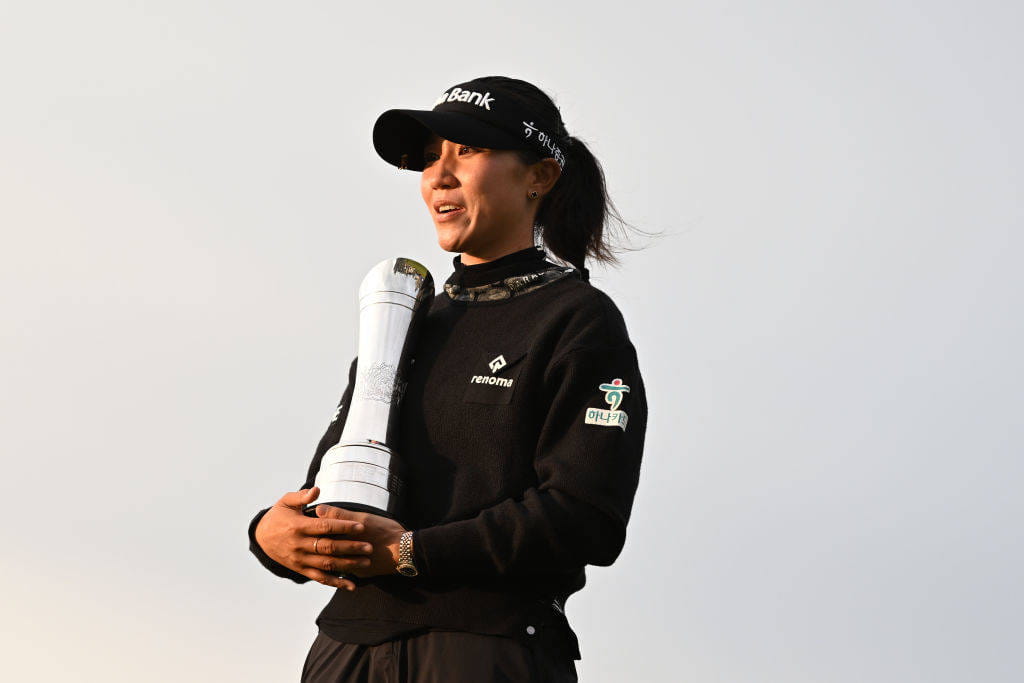 Lydia Ko poses with the trophy after winning the AIG Women